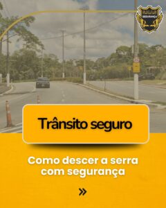 Card informativo com o título "Trânsito seguro: Como descer a serra com segurança". Ao fundo, uma foto de uma estrada arborizada com um carro e cones de sinalização. No topo, o logotipo da S.M.A.S Segurança.